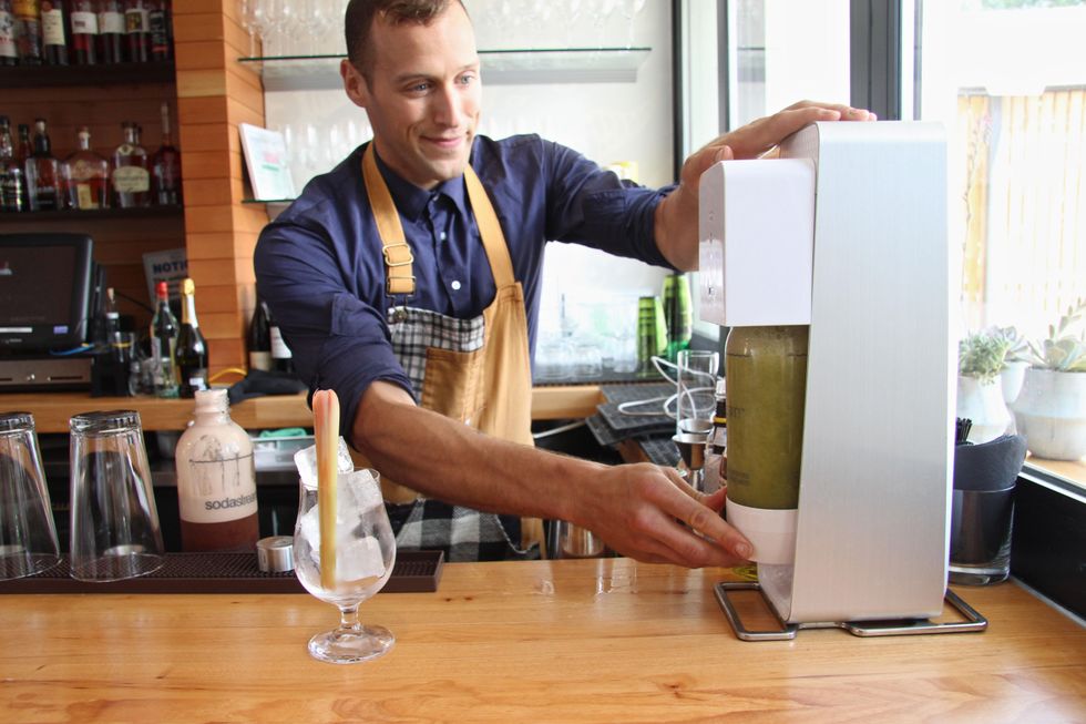 Michael Simon prepares celery ginger soda at Qui restaurant in Austin