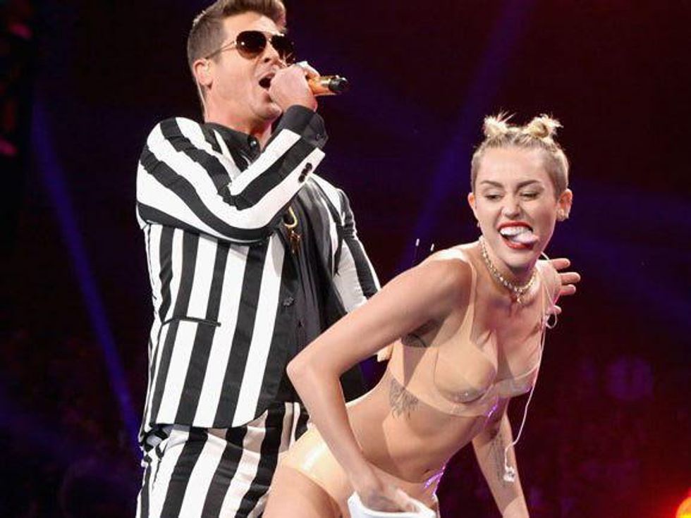 Miley Cyrus grinds on Robin Thicke at the VMAs