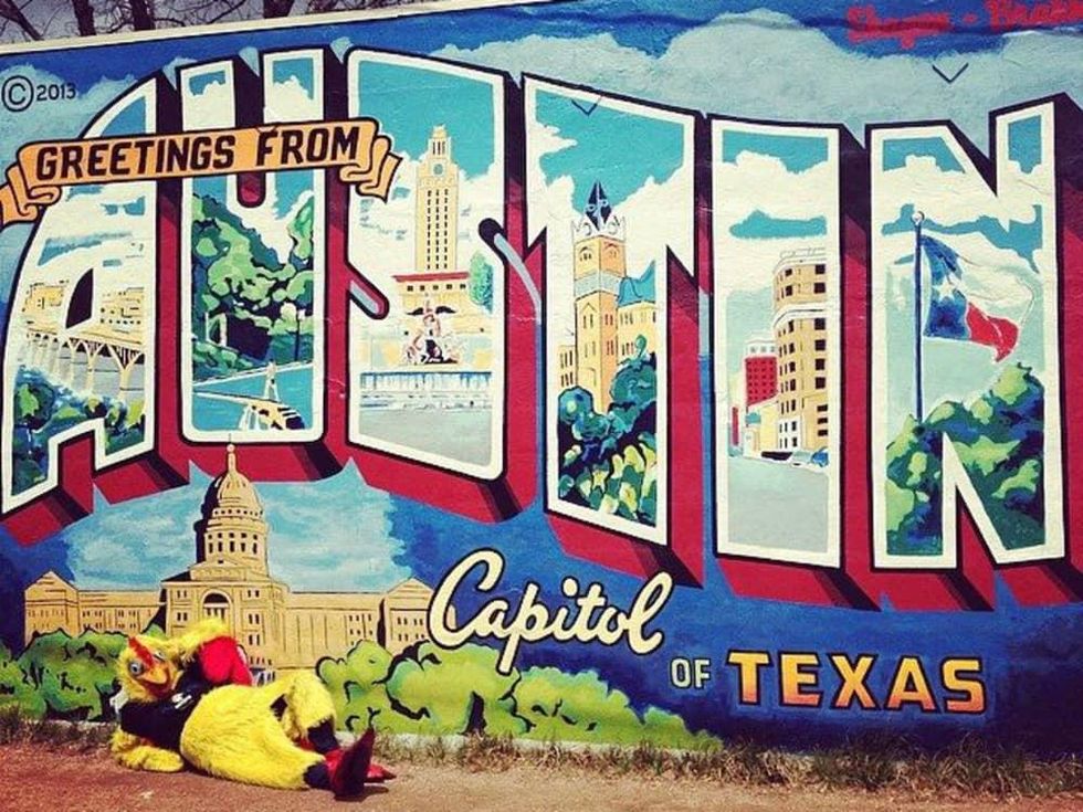 Moontower comedy festival's Mother clucker in front of Austin mural