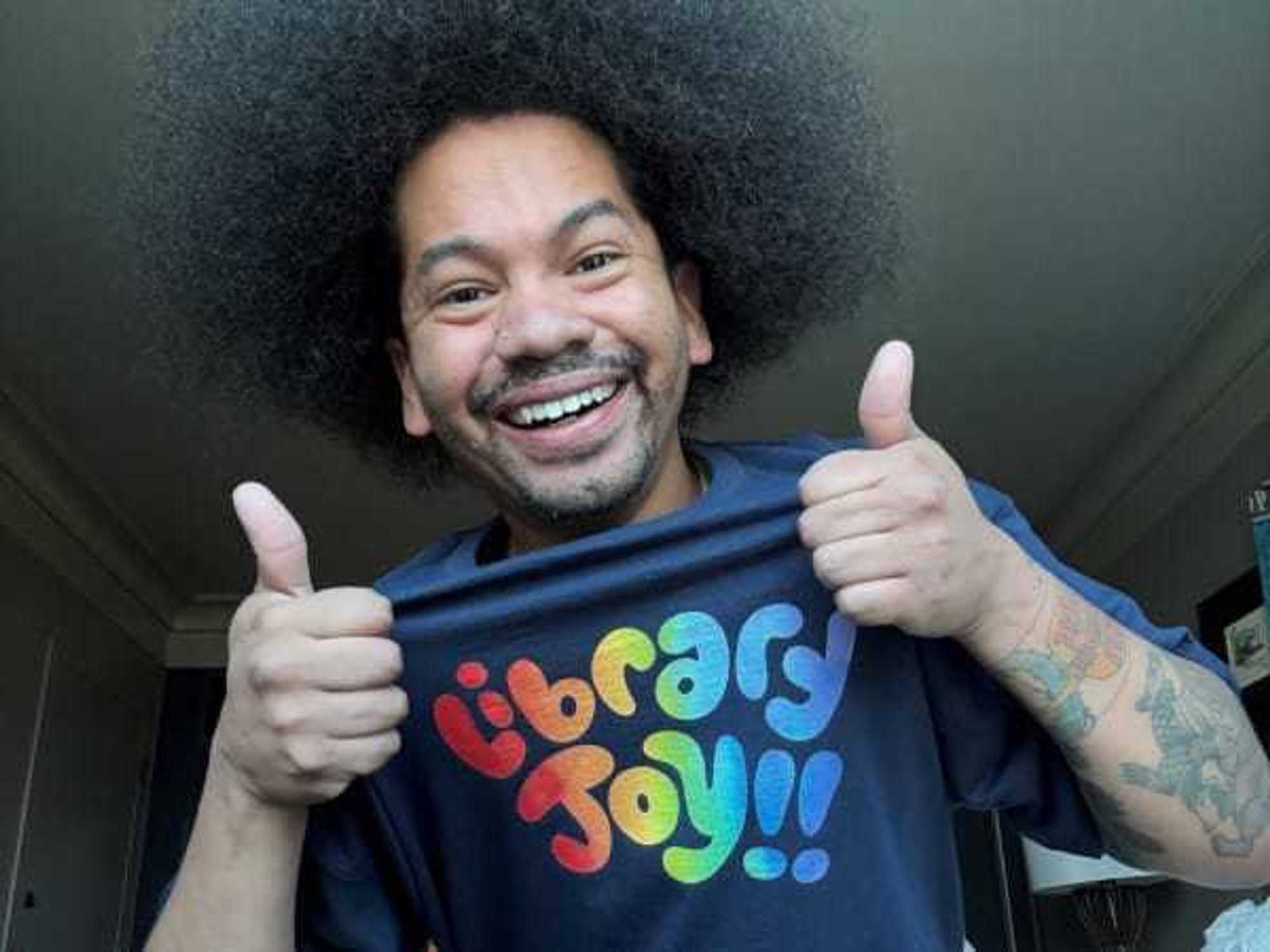 Mychal Threets wearing Library Joy shirt