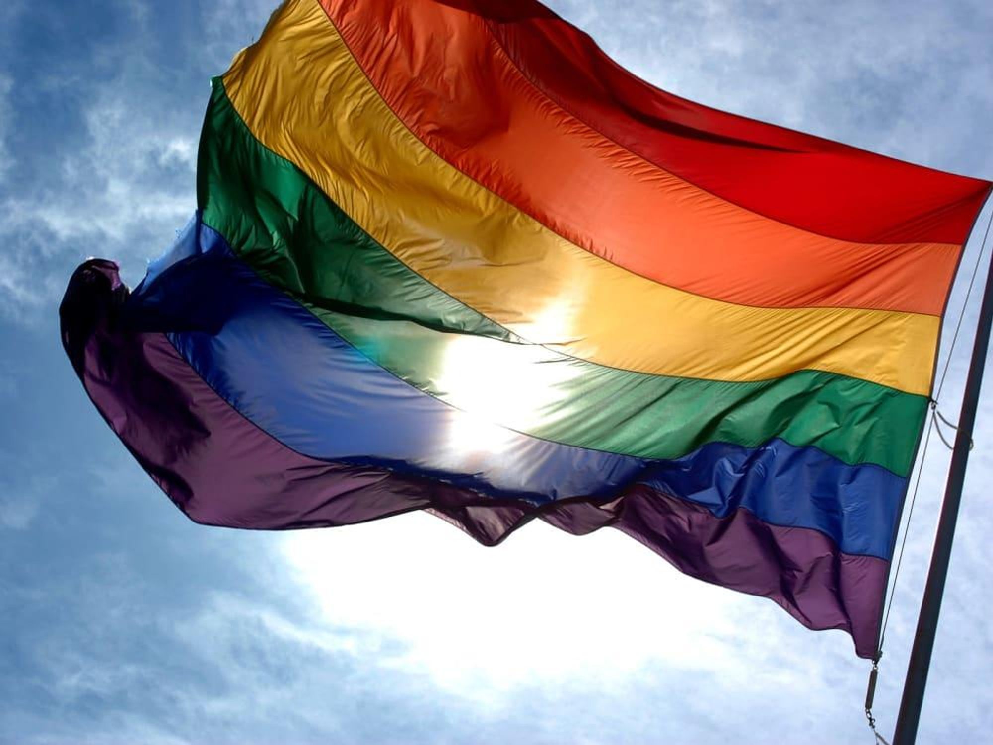 News_Rainbow flag_gay pride_sky_clouds