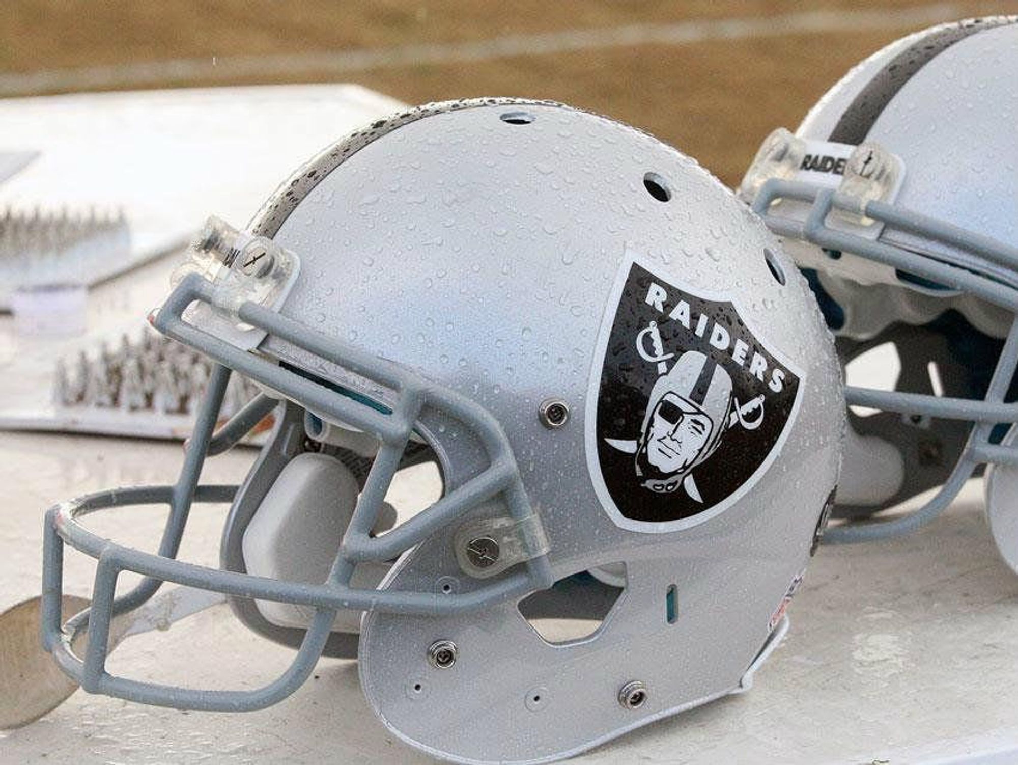 Oakland Raiders football helmets on bench