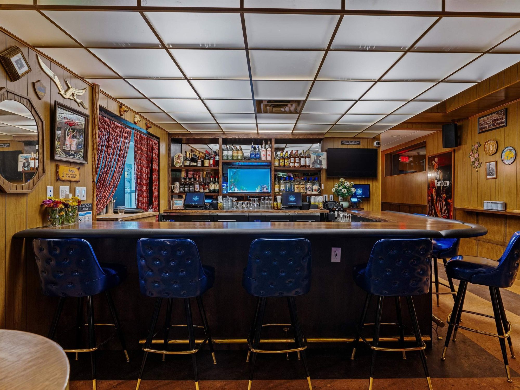 One of the bars in the Flower Shop Austin, featuring retro, Midwestern pub design elements.