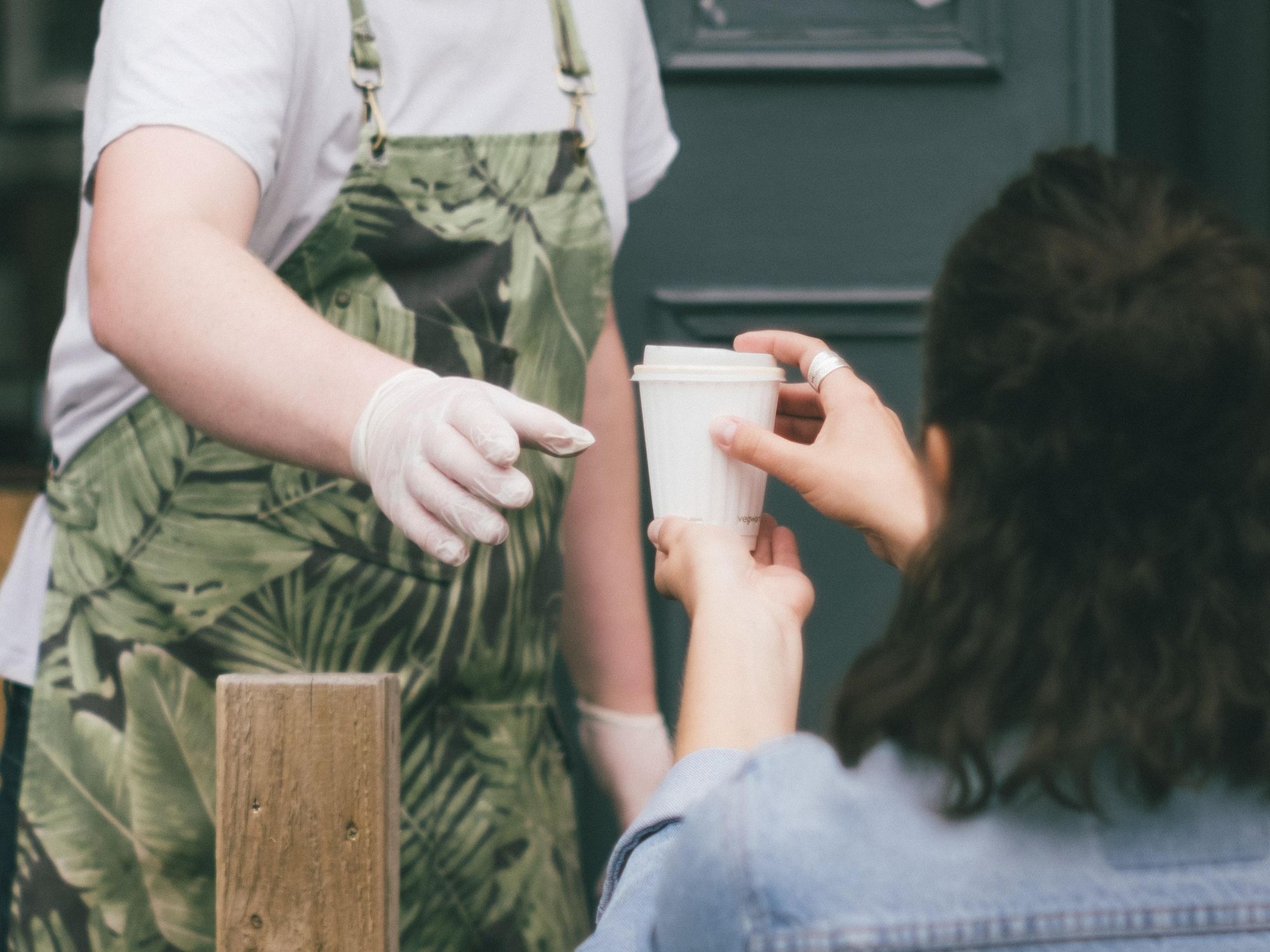 People handing off coffee.