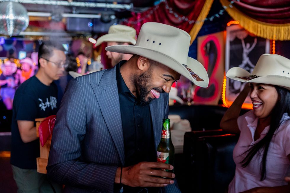 People in cowboy hats smiling