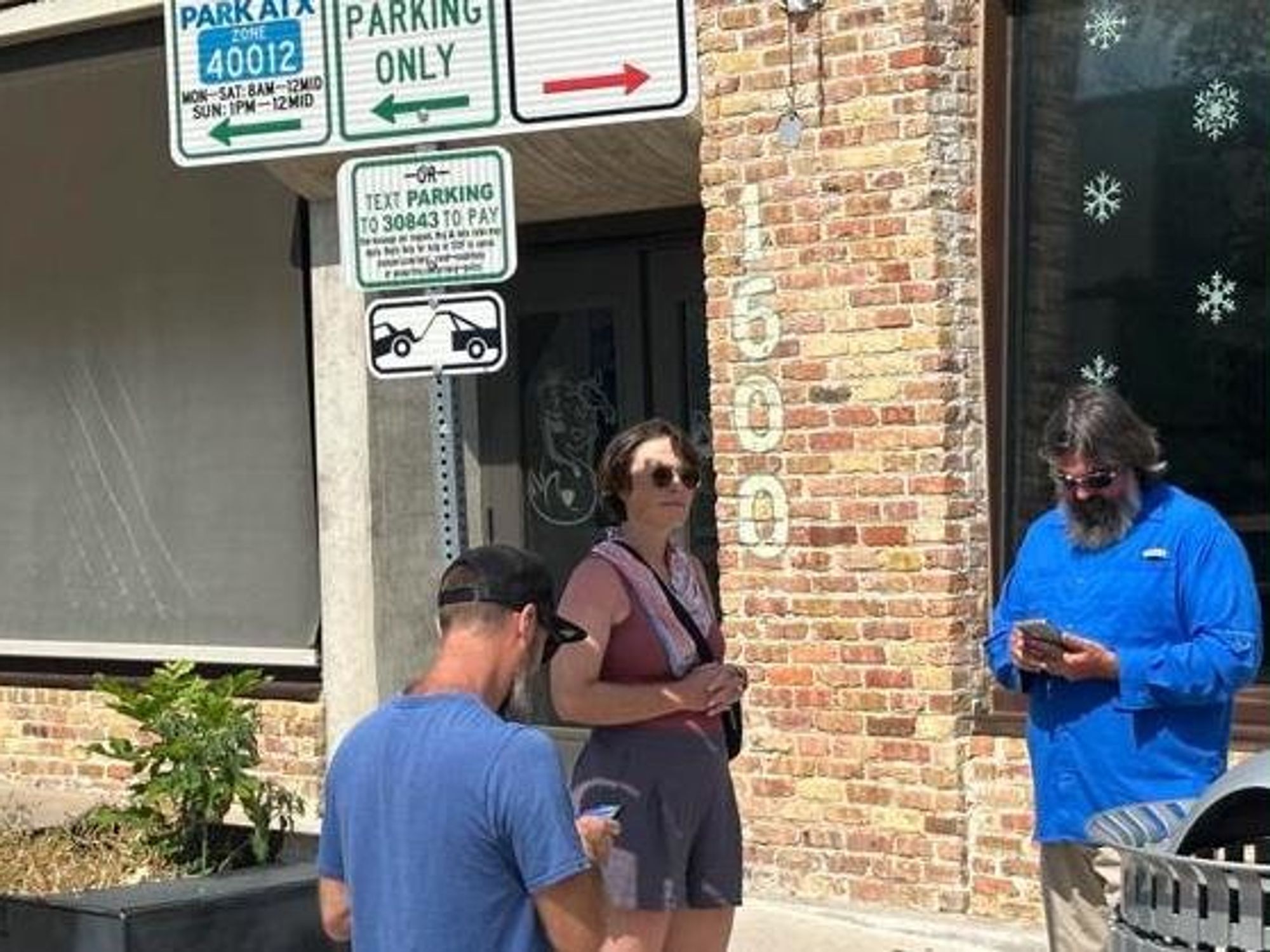 People paying for parking on South Congress Avenue in Austin