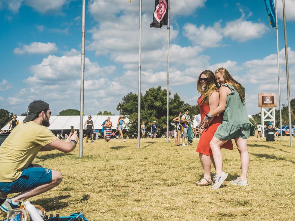 People pose for a friend taking a photo at Austin City Limits Festival.