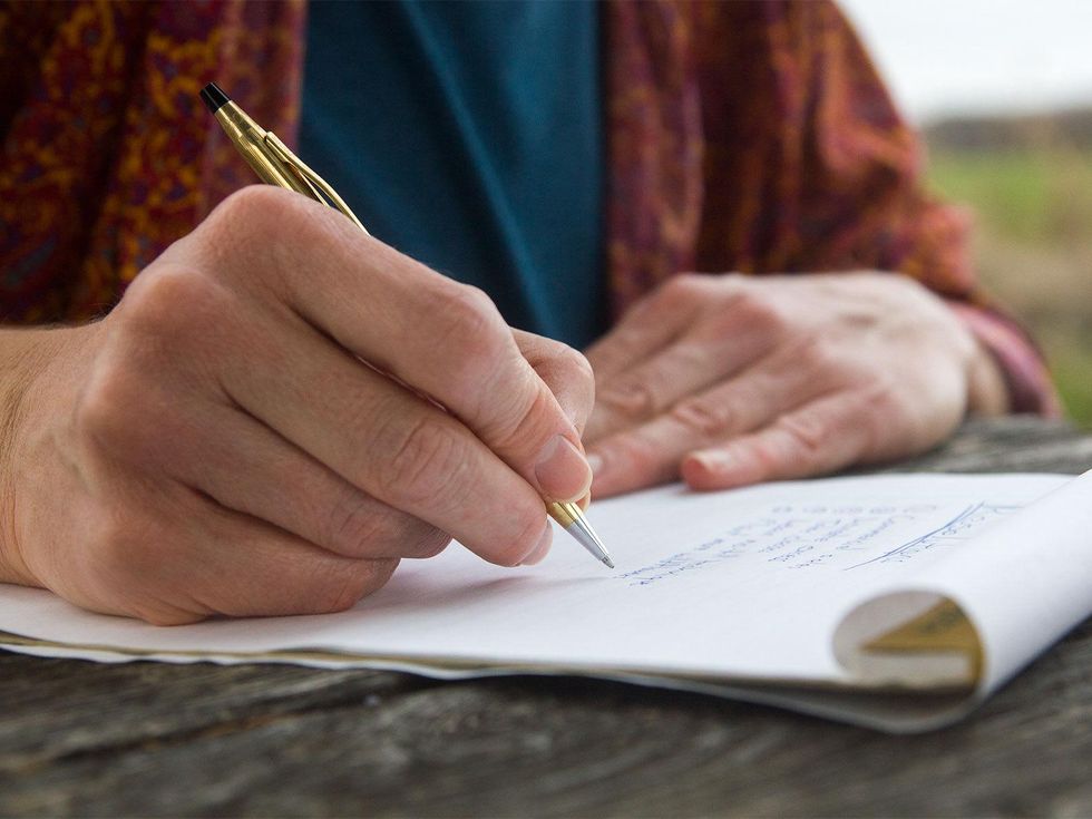 Photo of hands and pen
