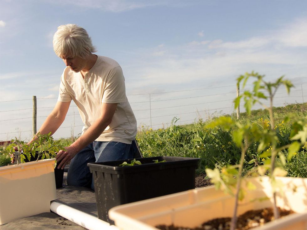 Photo of Marshall Hinsley with Dutch buckets