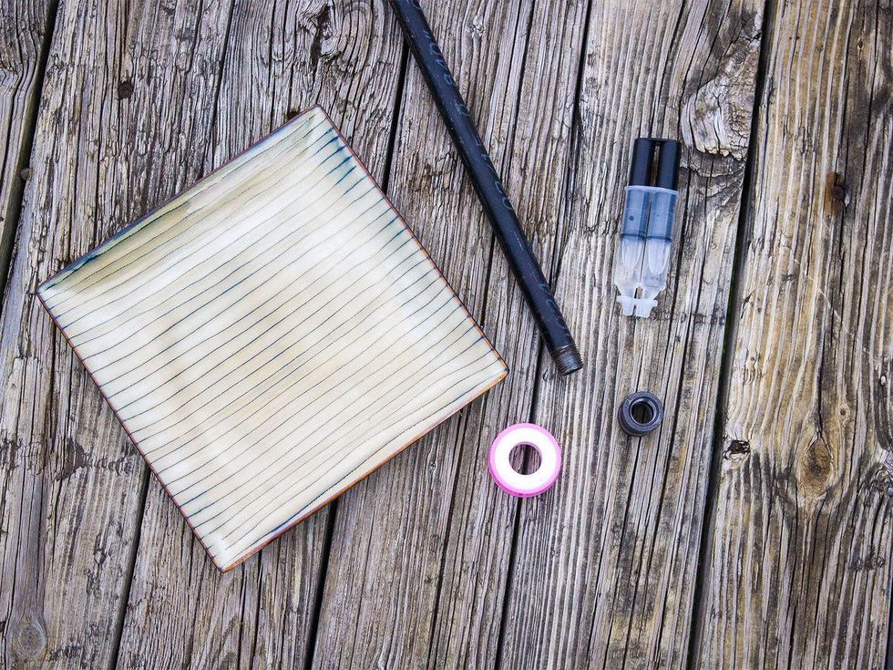 Photo of plate, pipe, coupling fitting and epoxy