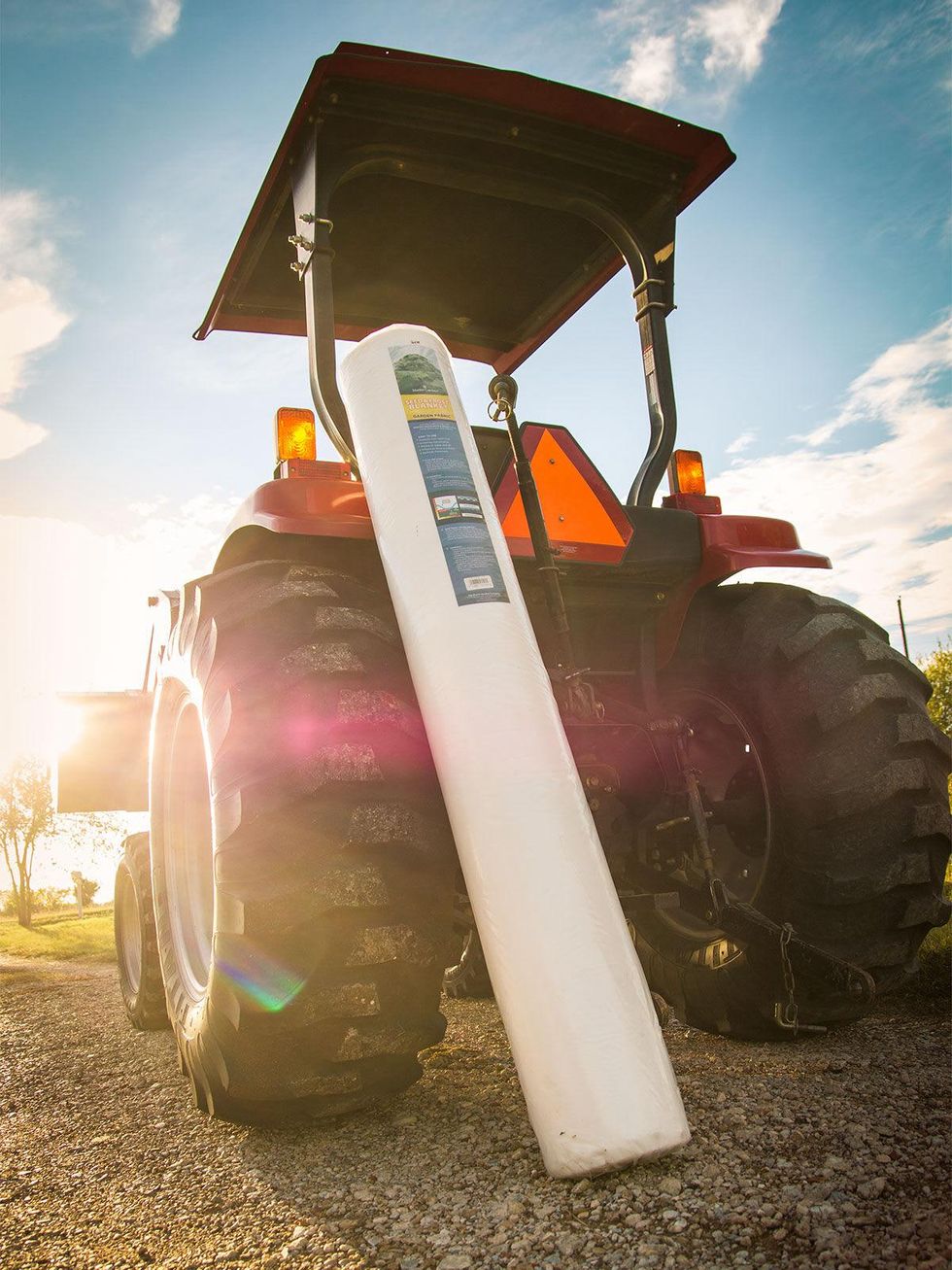 Photo of roll of frost blanket against tractor