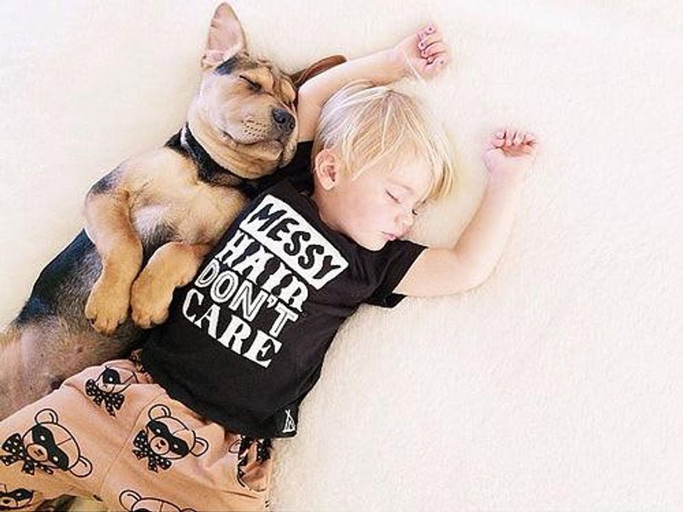 Puppy takes nap with kid