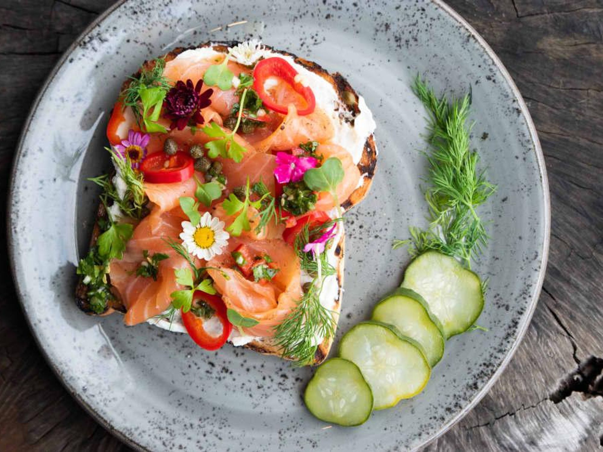 Salmon toast adorned with flowers, by Provision Dining House at The Triangle.
