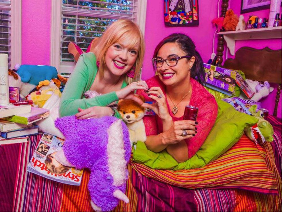 Sarah Pitre and Brandy Fons doing heart symbol in girly room for Forever Fest