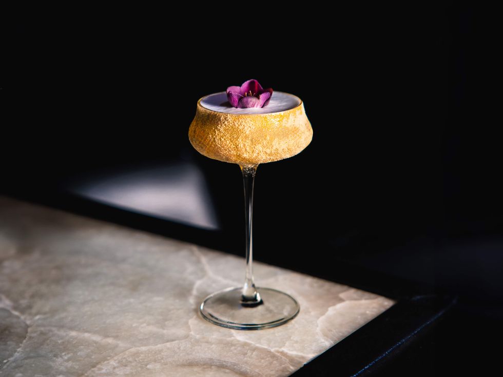 Show Business cocktail at The Eleanor is served in a coupe covered in golden honey powder.