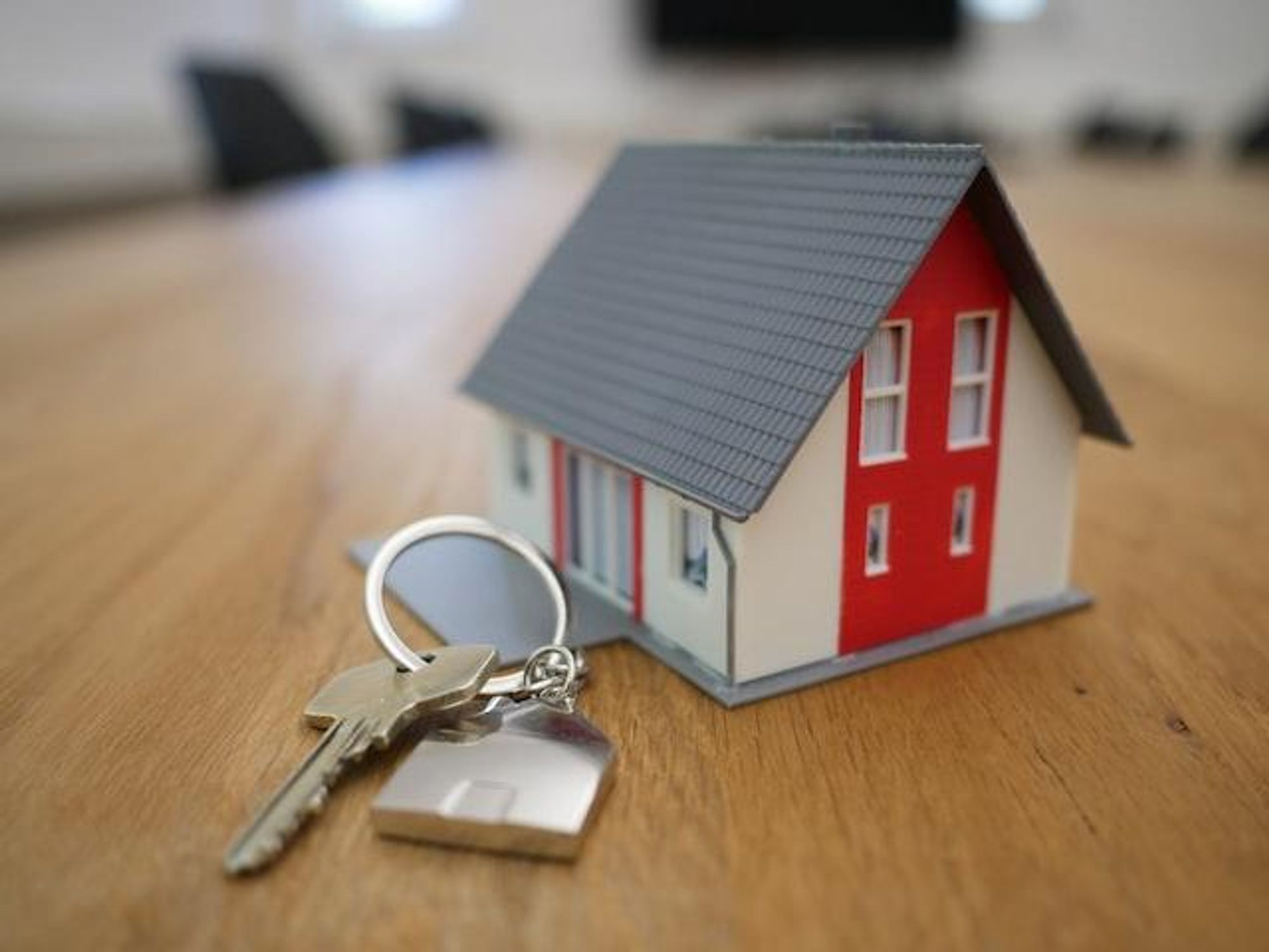 Small scale model of a house on a table with a set of keys