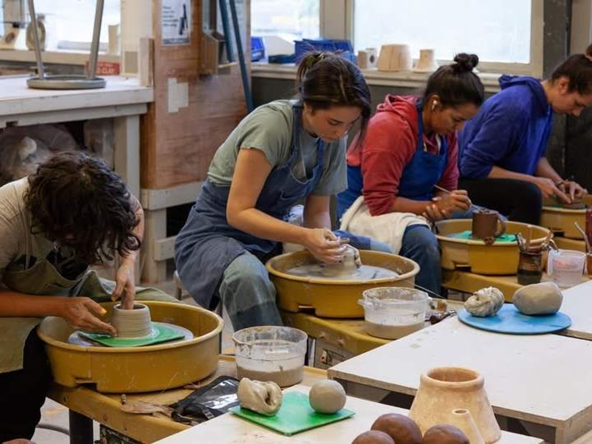Students in a wheel throwing class.