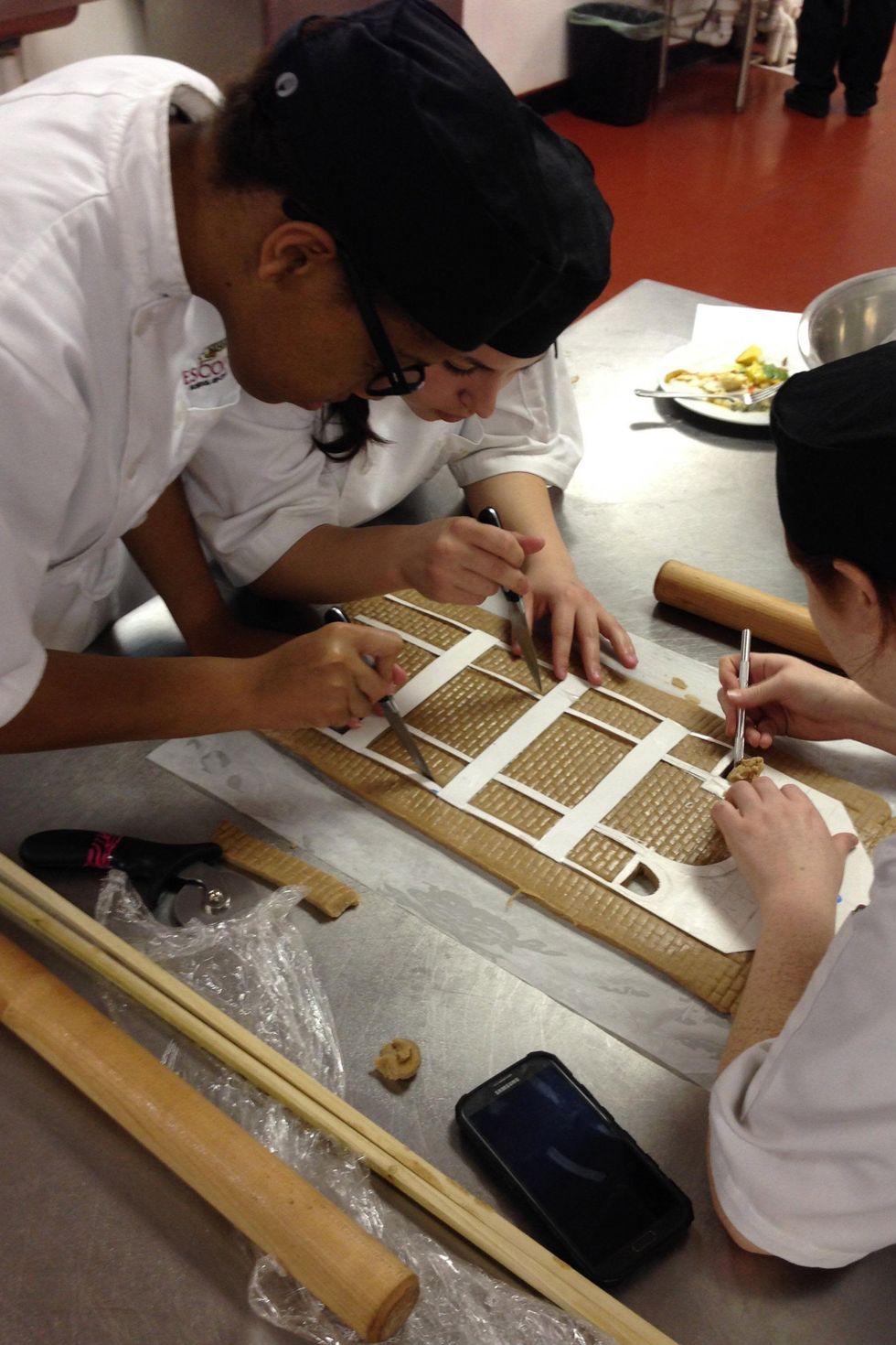 Students working on Driskill Hotel gingerbread house