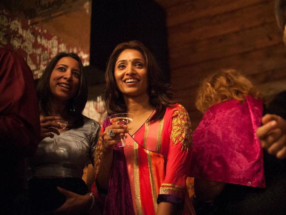 Taruna Jain and Hyma Chilakapati watch the fashion show at Bollywood Ball