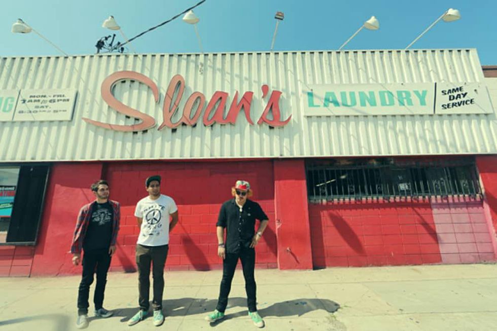 together PANGEA band standing in front of Sloan's Laundry