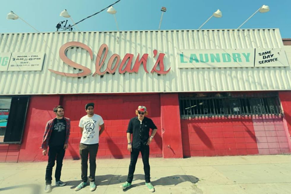 together PANGEA band standing in front of Sloan's Laundry