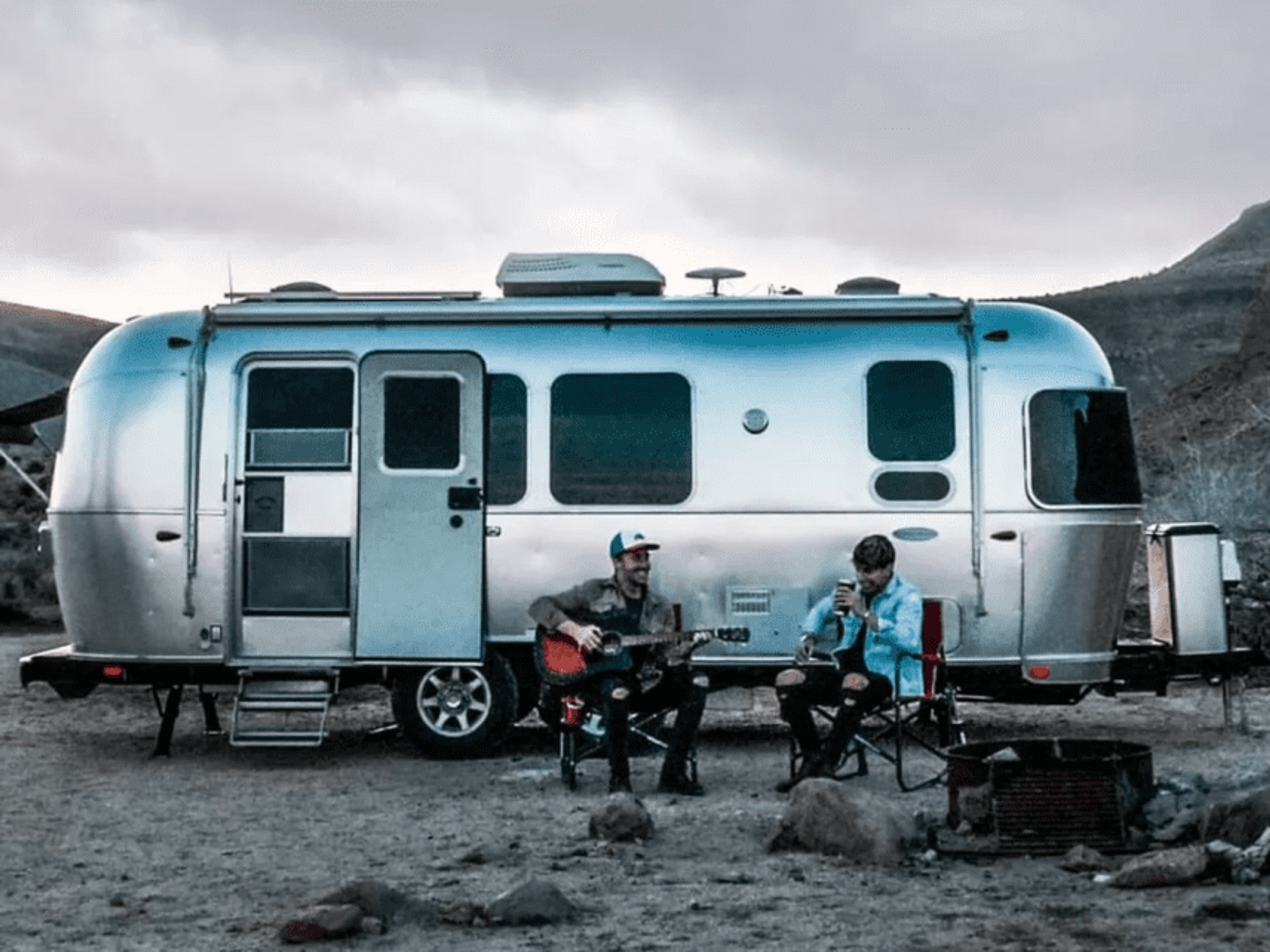 Two men in front of an Airstream