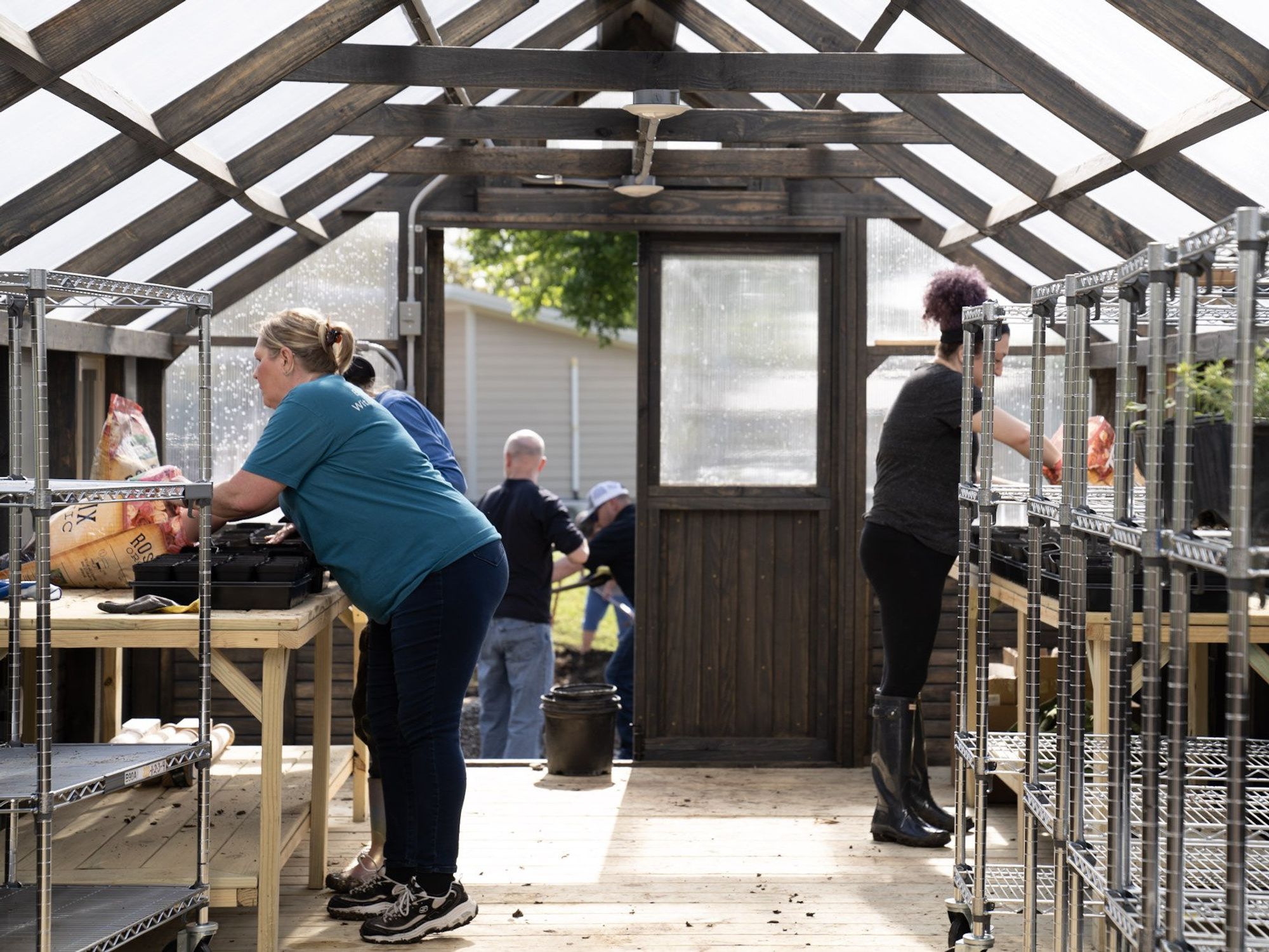 Volunteers working in the Community First! Village greenhouse