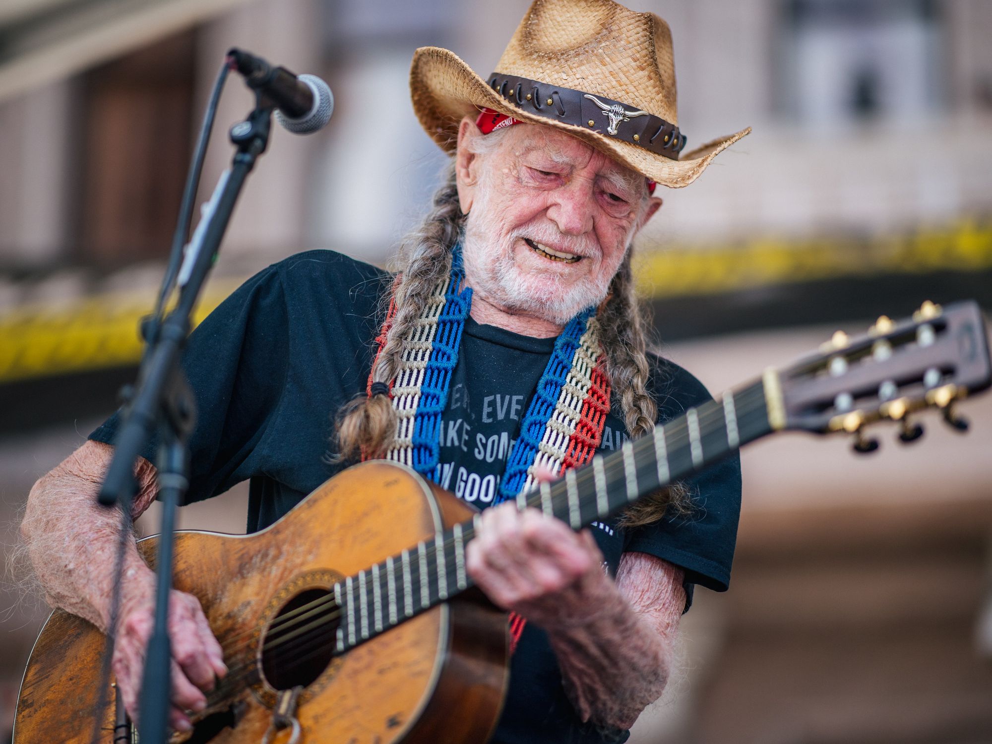 Willie Nelson playing at rally