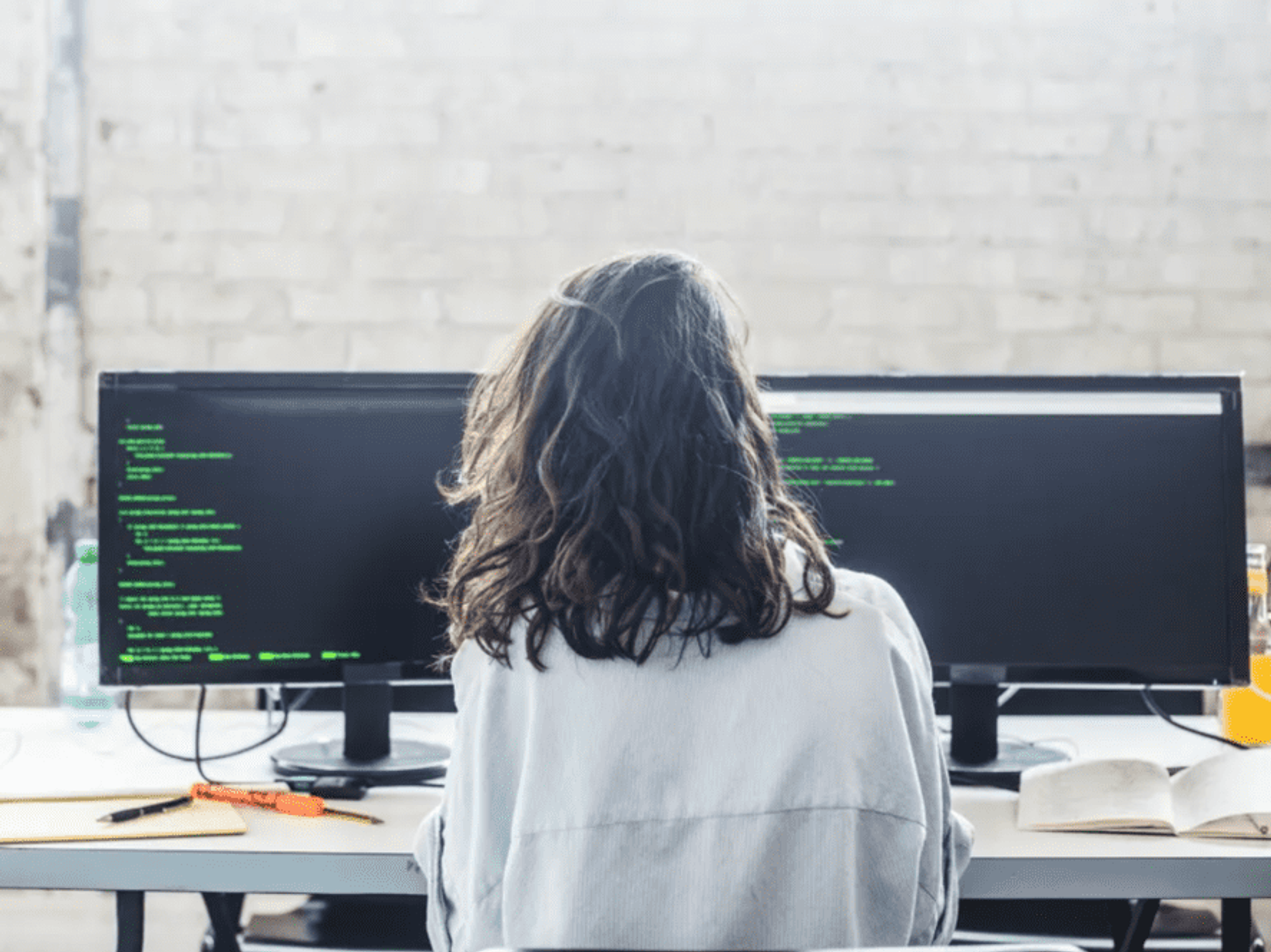 woman at computer screens working office