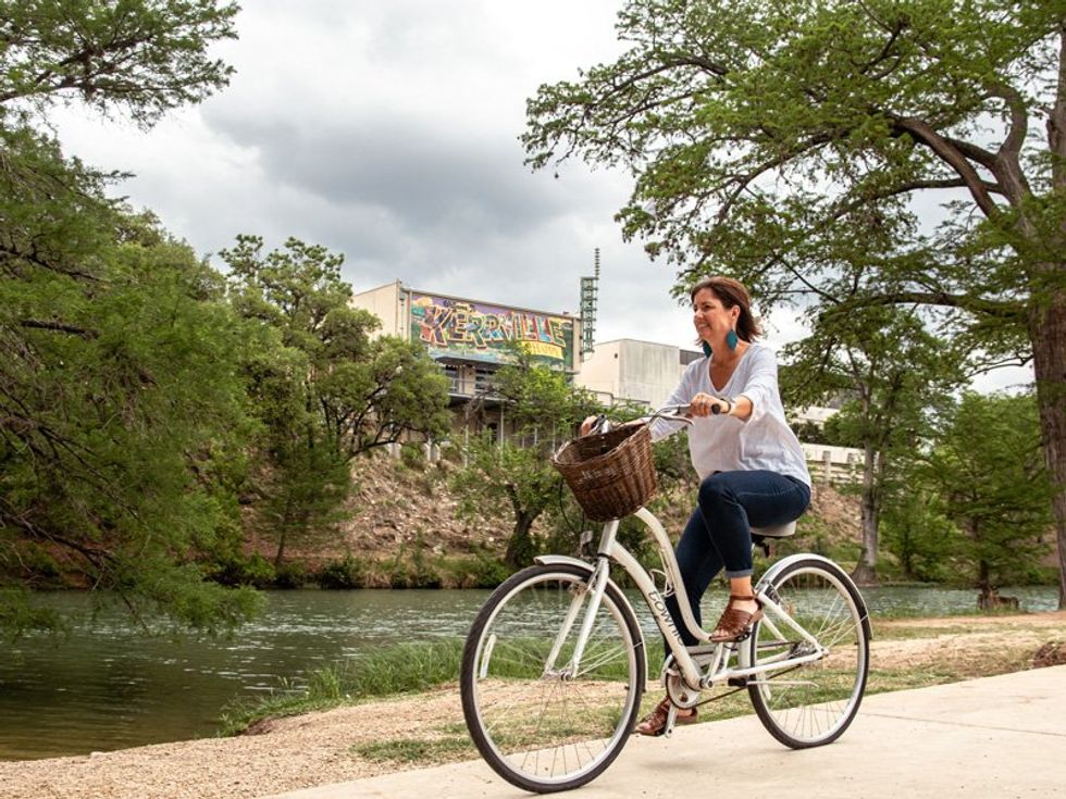 Woman bicycling at Riverside Park in Kerrville