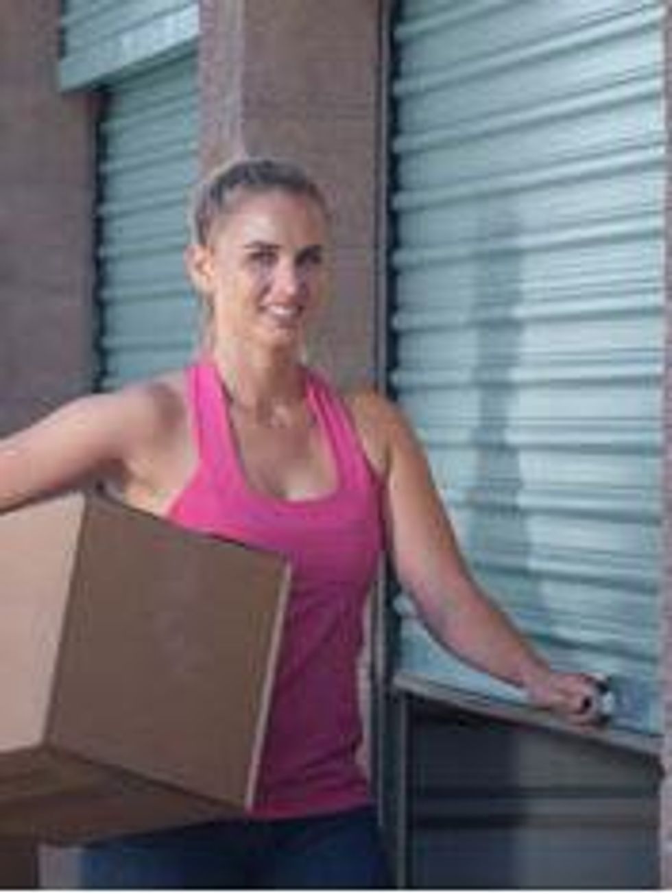 woman with box near storage unit