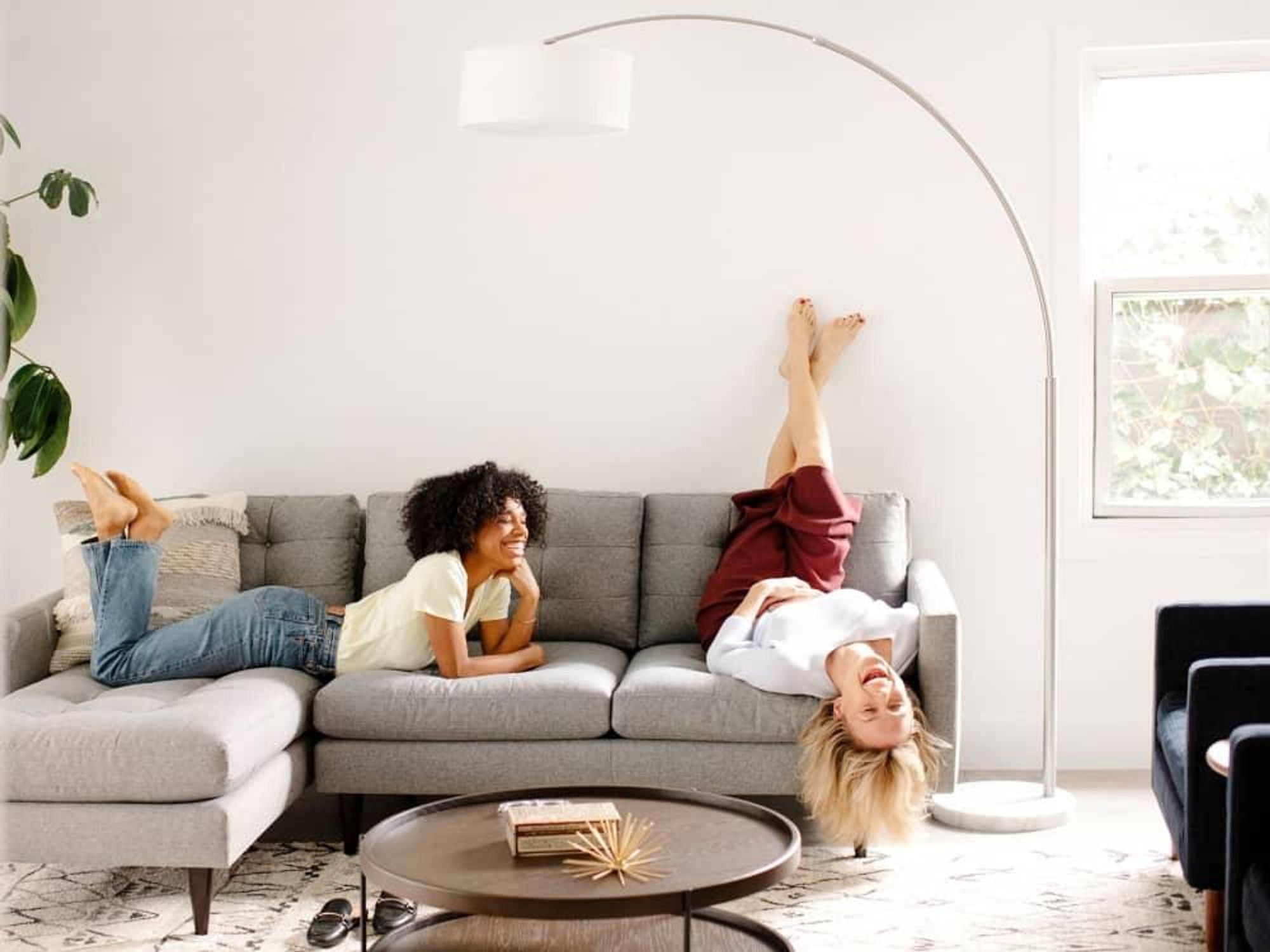 Women laughing on a sofa