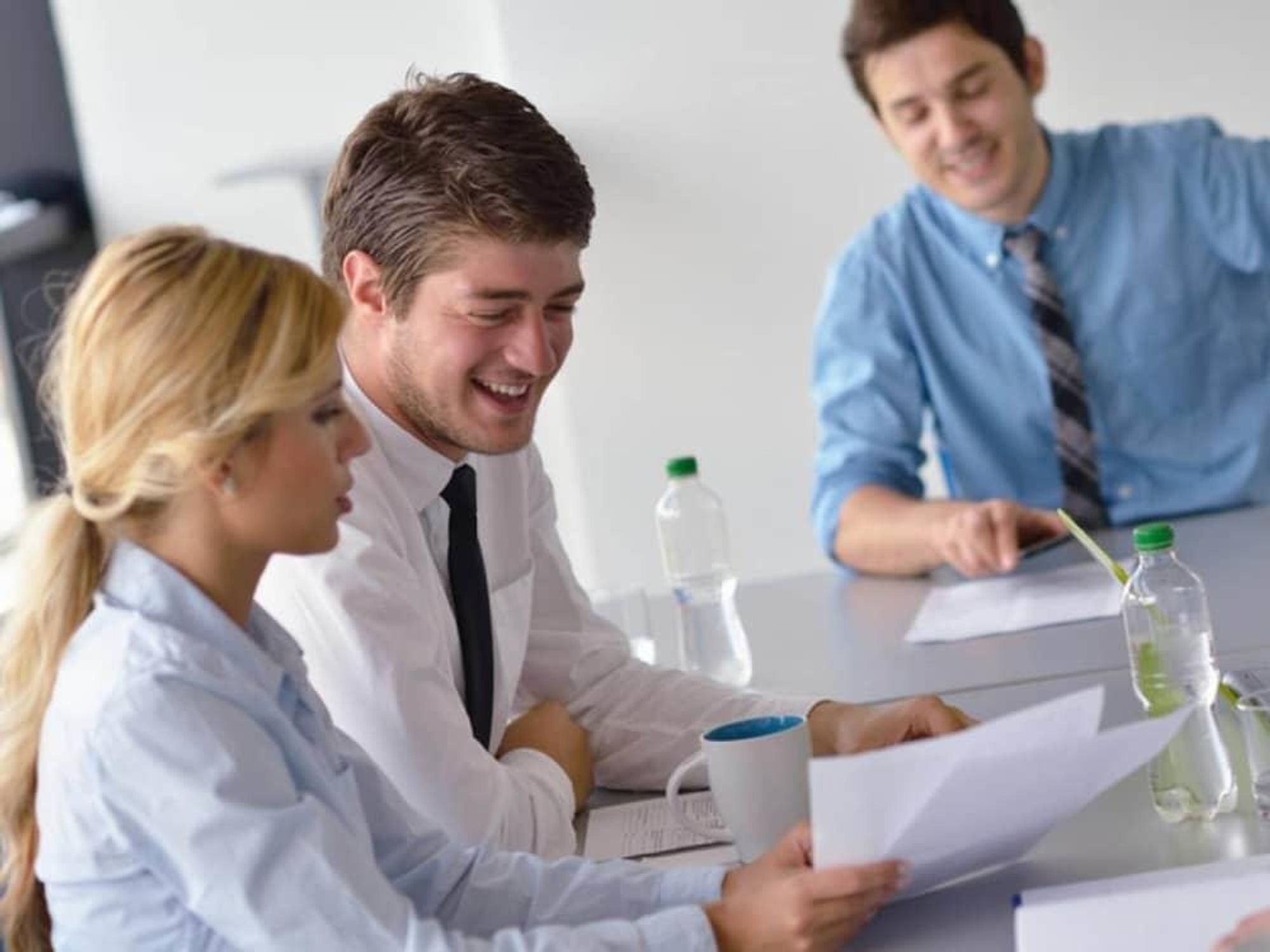 young business professionals in office at conference table
